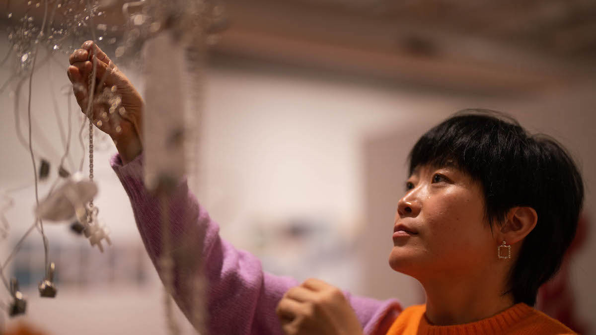ANU graduate Cathy Zhang installs her work NetPiece at the School of Art and Design Gallery.