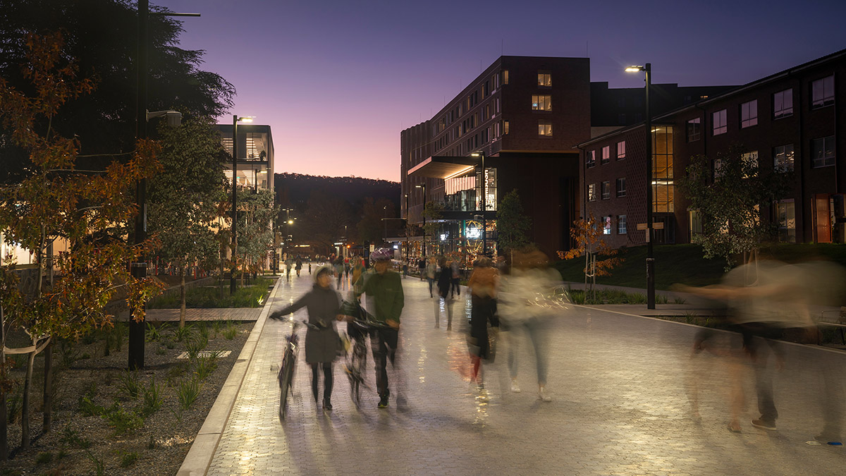 University Avenue at dusk, with people walking along it.