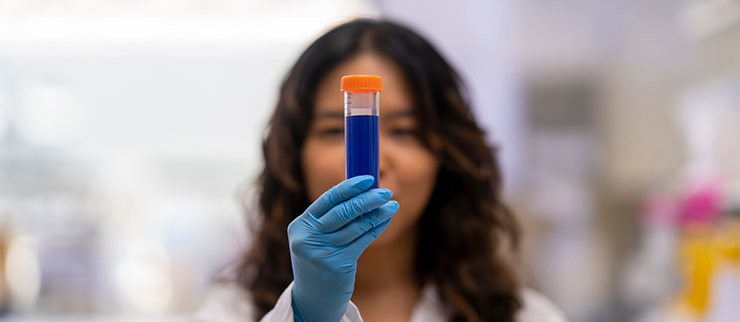 A researcher watching at a tube