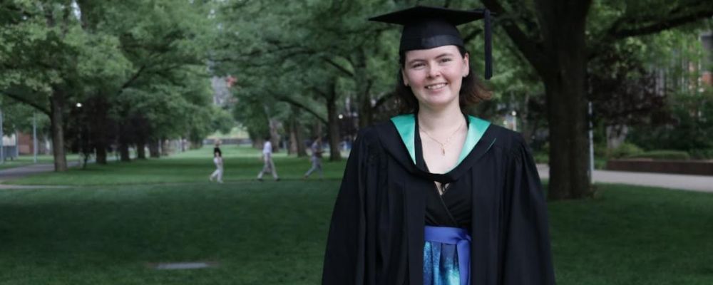 ANU graduate and scholar Riley Guyatt in her ANU graduation ceremony cap and gown. 