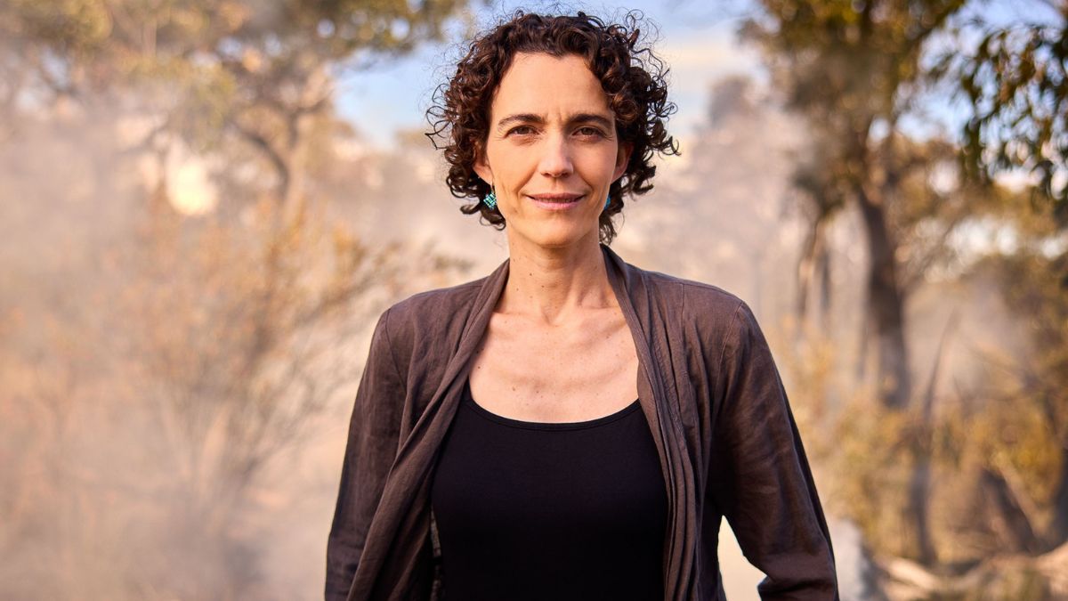 ANU researcher and professor Marta Yebra looks into the camera as she stands in Australian bushland.