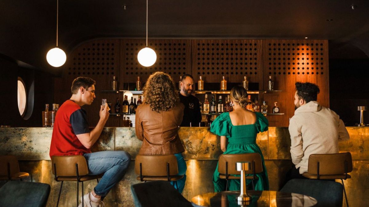 A group of young people sit at a bar in Canberra.