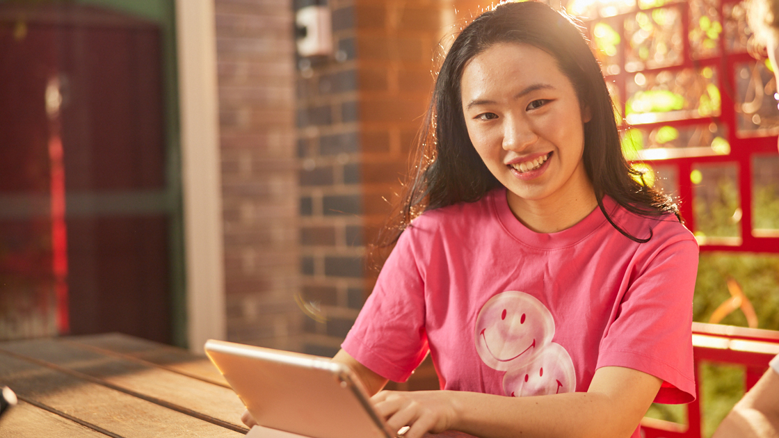 an ANU student is smiling in front of the camera