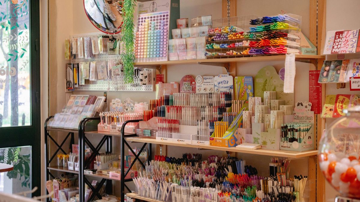 A shelf of pens and miscellaneous products in a stationery shop.